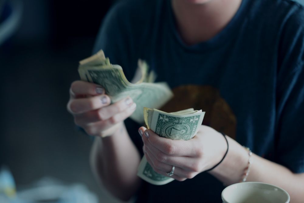 Woman with hand full of cash